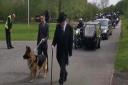 Mally's dog Blaze leading the funeral procession