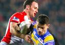Leeds' Stevie Ward is tackled by St Helens' Lance Hohaia and Sia Soliola. Pic: SWpix.com