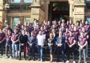 Michael Smith (front, middle) and the Saints squad outside the town hall with dignitaries