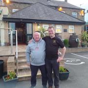 Landlord Paul Draper, with dad Alan outside the Junction this year, with the pub's extension visible in the background