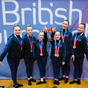 Hope gymnasts celebrate their contribution to the North West's victory in the team competition. Pics: Seam Kilmurray.
