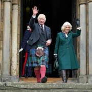 King Charles and Camilla wave as they leave Dunfermline Abbey.