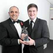 Liam Burbridge receives his Saints Courage Award from Dave Hutchinson