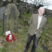 Jimmy Lamb beside a soldier's grave in St Nicholas' churchyard
