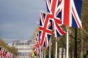 Union flags hang from the street furniture outside Buckingham Palace on the Mall, London, ahead of the coronation of King Charles III