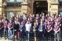 Michael Smith (front, middle) and the Saints squad outside the town hall with dignitaries