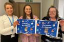 Holly Hale, Francine Daly and Cheryl Farmer promote the Christmas Art Appeal to brighten the spirits of hospital patients this Christmas.