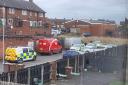 Four police vehicles behind the shops on Ashtons Green Drive