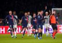 Paris Saint-Germain players surround referee Szymon Marciniak as they appeal for a penalty (Owen Humphreys/PA)