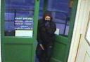 This CCTV still shows a woman holding a knife during the robbery in Sutton Road.