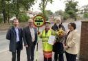 Lollipop lady Margaret celebrating with St Helens councillors and officials