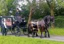Mel's coffin being transported to St Helens Crematorium by two horses