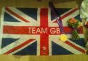Pride of Britain: Ed Clancy shared this image, of his gold medal and a flag he was given by the crowd, with his Twitter followers.