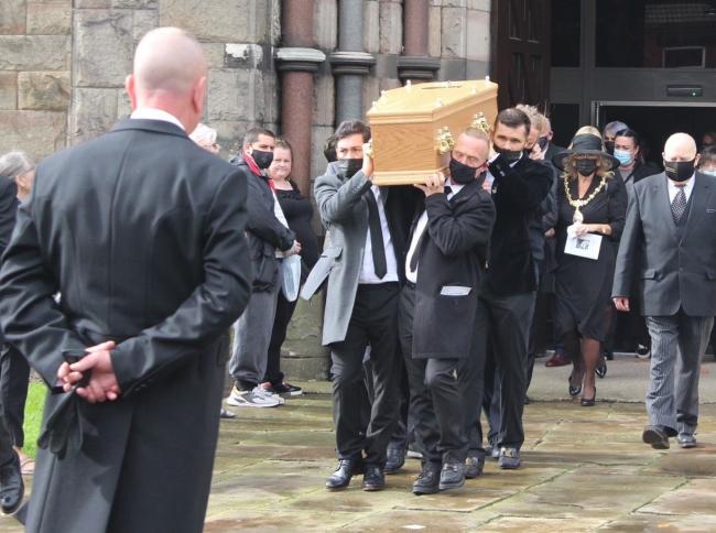 Johnny's coffin carried out by those who loved him at Lowe House Church