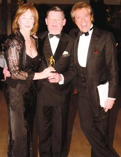 Keith Holmes (middle) in 2008, reciving an accolade for accolade for Outstanding Services to Danceat the Carl-Alan Awards in 2008, with Shirley Anne Field (left) and Lionel Blair (right)