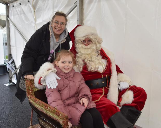 St Helens Star: Santa and a local family at the festive fun day over the weekend