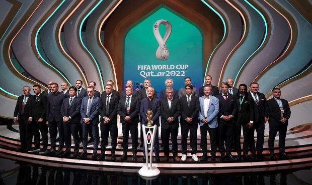 St Helens Star: Managers, including England manager Gareth Southgate (back row third left), on stage during the FIFA World Cup Qatar 2022 Draw. Picture: PA