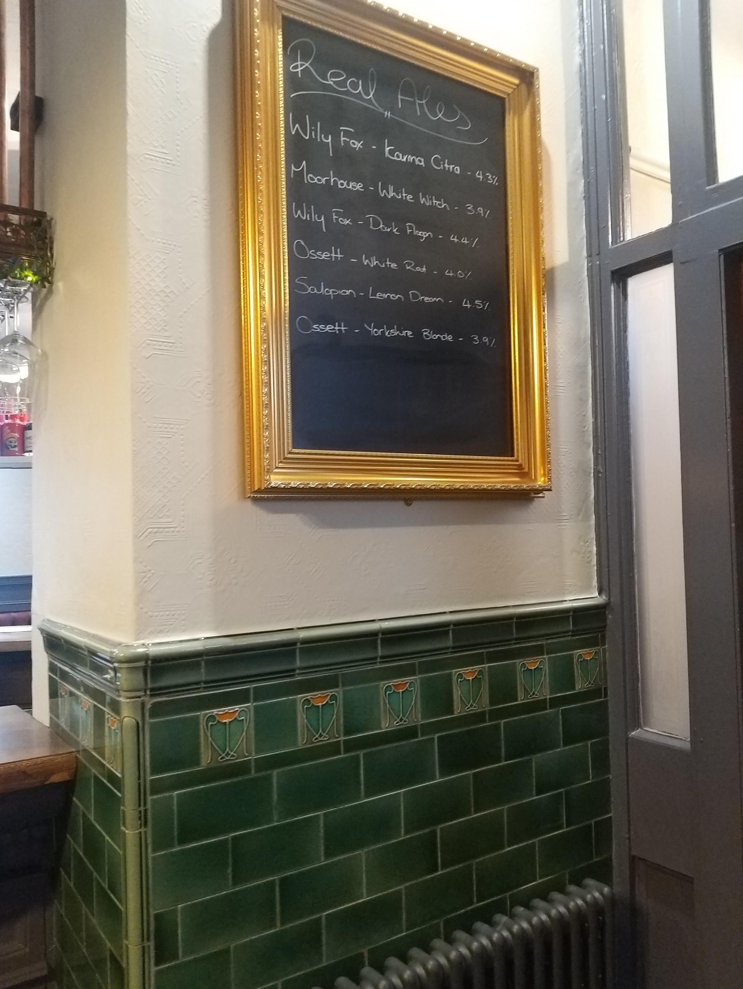 A real ale list, above some original tiling, more than a cenrtury old, among the pubs features