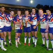 Saints players line up with the XXXX Trophy after the record-breaking 46-14 victory over New Zealand in 2006. Leon Price, Paul Wellens, Keiron Cunningham, Sean Long, Lee Gilmour, James Graham and Ade Gardner