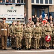Young service personnel stand as the parade takes place in Earlestown