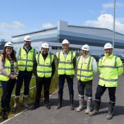 Councillor Kate Groucutt, Council Leader Councillor David Baines and officials from the developers at Omega West outside one of the new units being built