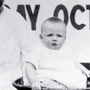 A baby	being weighed in the film St Helens Health Week 1923