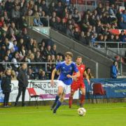 St Helens Town's Alfie Stott against Wigan Town in front of the South Stand at the Totally Wicked Stadium