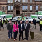 Councillors and council officials with some of the new electric fleet