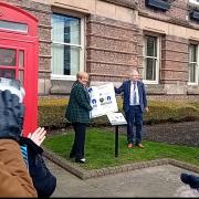The plaque being unveiled outside St Helens town hall