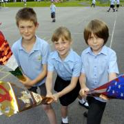 MAGICAL: Bleak Hill Primary School pupils (left to right) Tom Preston, Kerrie-Rose Evans and Ethan Southward will be among 6,000 children lining the Olympic Torch route in St Helens.